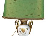a lamp that has a green shade on top of it