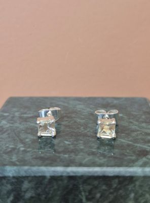 une paire de boucles d'oreilles posées sur une table en marbre