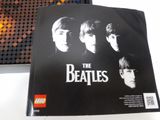 the beatles lego book is sitting on a table next to a lego light