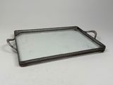 a metal tray with a glass top on a white surface