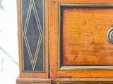 a wooden cabinet with a drawer on top of it