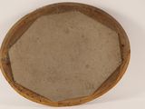 a wooden bowl with a brown lid on a white surface