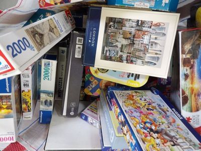 a pile of puzzles and books on the floor