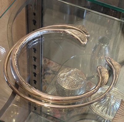 a glass display case with a silver object in it