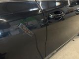 a black car with a sticker on the side of it