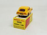 yellow toy car sitting on top of a box on a white surface