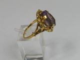an image of a gold ring with a large amethorate stone