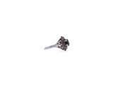 a ring with a blue stone in it on a white surface