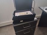 a black filing cabinet with a computer on top of it