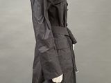 an image of a mannequin wearing a black trench coat