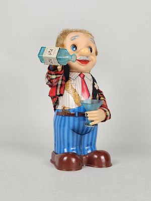 a figurine of a man drinking from a bottle