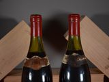 two bottles of wine sitting next to each other on a table