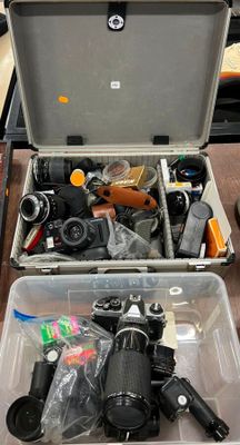 a box full of cameras and other items on a table