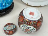 a vase and two other decorative items on a table