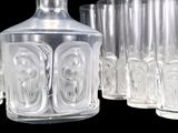 many glasses and a decanter sitting on a table