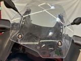 a close up of a motorcycle with a clear windshield