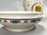 a bowl and a cup sitting on a table next to each other