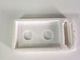 a plastic container with two holes in it on a white surface