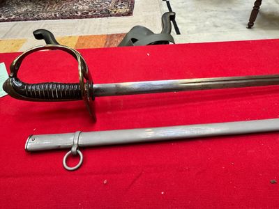 a sword that is laying on a red table