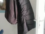 a coat rack with a coat hanging on it in a room