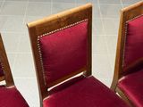 three chairs with red upholstered seats are sitting on a tile floor
