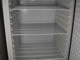 an empty refrigerator with its door open in a room