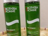 two bottles of biotherm home age fitness lotion sitting on a basket