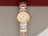 a silver and gold wrist watch on display in a case