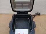 a black container with a sign on it sitting on the floor