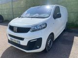 la petite camionnette blanche est garée dans le parking