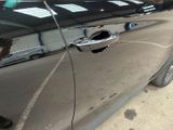 a close up of a car door handle on the side of the road