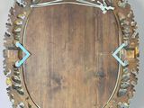 a circular mirror with a wooden frame on the wall
