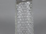 a close up of a clear glass vase with a bird on it