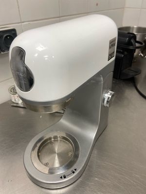 a white blender sitting on a counter in a kitchen