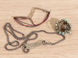a necklace and a bracelet on a wooden table