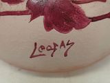a close up of a vase with a flower painted on it