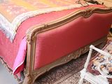a bed that has a pink blanket on top of it