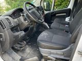 the interior of a van with the door open and the driver ' s seat down