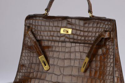 brown alligator skin handbag with gold hardware and handles