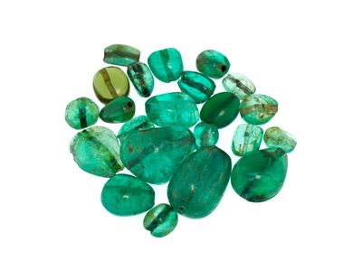 a close up of a bunch of green stones on a white surface