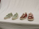 three pairs of shoes are lined up on a white surface