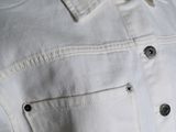 an image of a white denim jacket with buttons