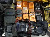 many cell phones and other electronic equipment on the table