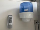 a blue and white toilet paper dispenser on the wall