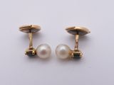 a pair of gold and pearl cufflinks
