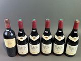 six bottles of wine lined up in a row on a table