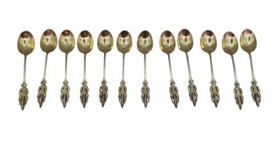 six spoons are lined up in a row on a white surface