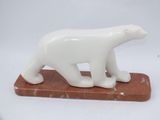 white bear figurine on a marble base on a white background
