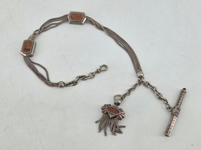 a silver bracelet with a cross and charms on it