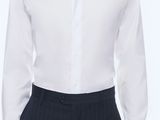the man is wearing a white shirt and black pants
